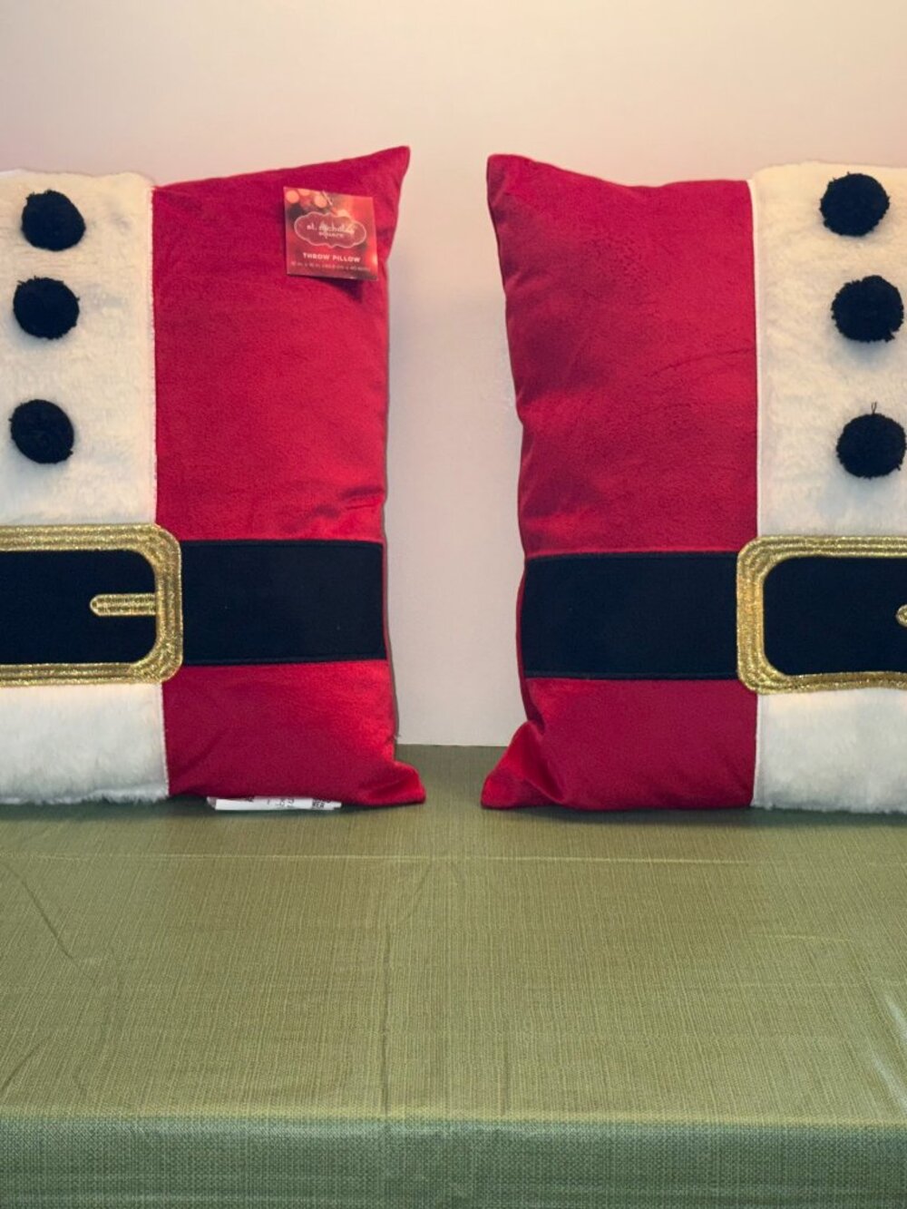 Two St. Nicholas Square accent pillows with a Santa theme
